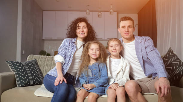 istock Girls siblings fall on cosy sofa and enjoy playing together 1455540990
