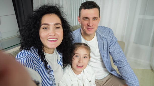 istock Parents and daughter talk with relatives on videocall 1455541125