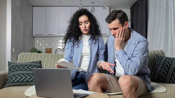 istock Couple tries to solve problems with expensive utility bills 1455541232