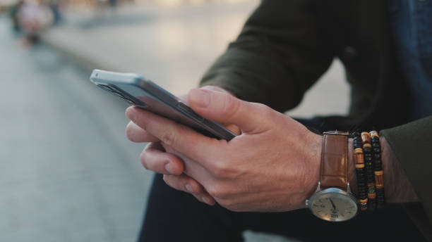 istock lose-up of man hands using mobile phone 1455543441