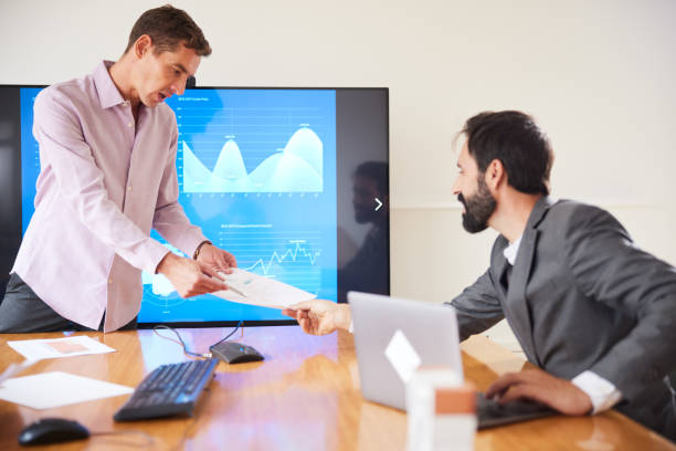 istock Two businessmen  sharing information at team meeting 1455543715