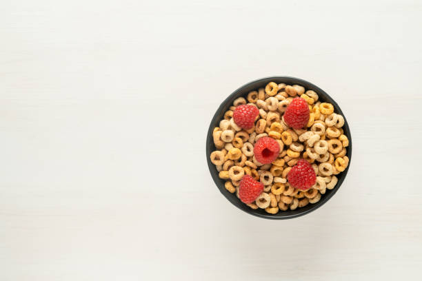 istock Cereal bowl with raspberries on a white table. Healthy eating concept. Top view, copy space 1455543866