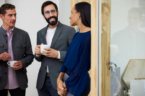 istock Three team members enjoying a coffee break during a busy day 1455543928