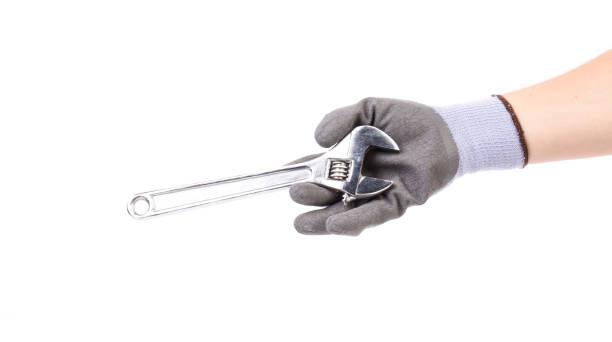istock A gloved hand holds an adjustable wrench. 1455545354