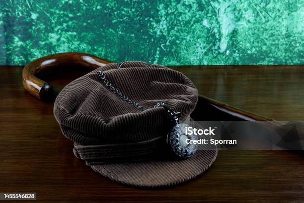 Corduroy Hat With Walking Stick And Pocket Watch On A Varnished Table Top Stock Photo - Download Image Now