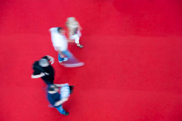 istock Group of Young People Walking on Red Carpet, Elevated View 1455548826