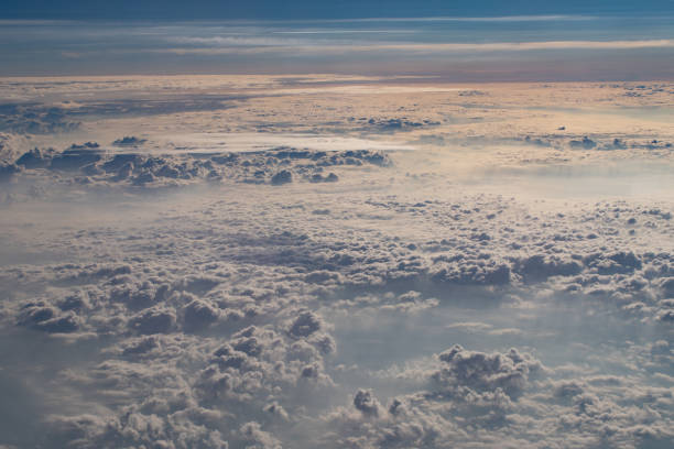 istock beautiful fluffy clouds from the window of the plane 1455549124