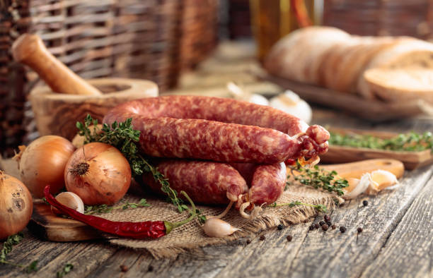 istock Sausage with bread and spices on a old wooden table. 1455549216