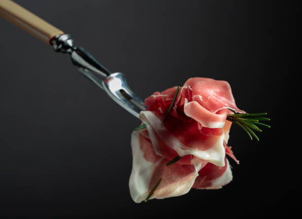 istock Sliced prosciutto with rosemary. 1455549900