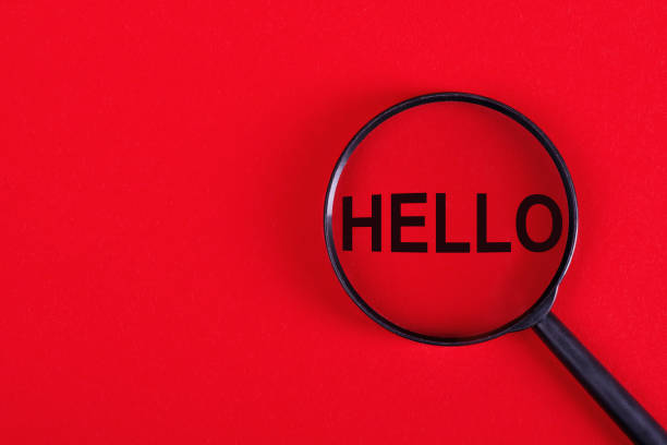 istock Magnifying glass with the inscription HELLO on a red background. 1455551738