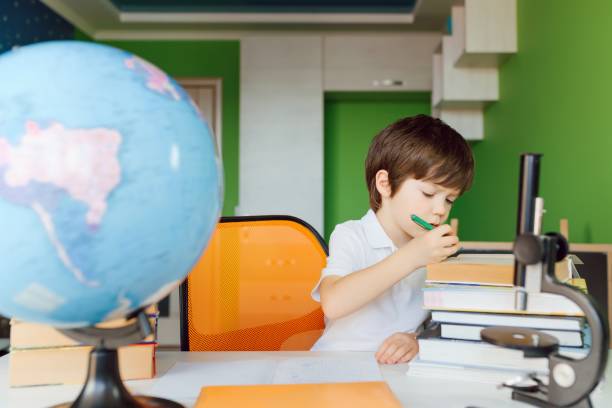 istock Thinking child bored, frustrated and fed up doing his homework 1455553204