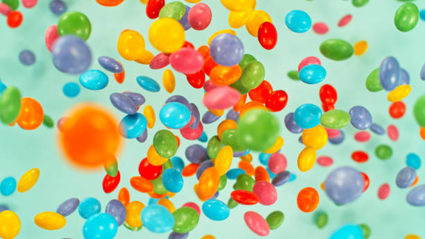 Sweet candies flying, freeze motion against pastel background