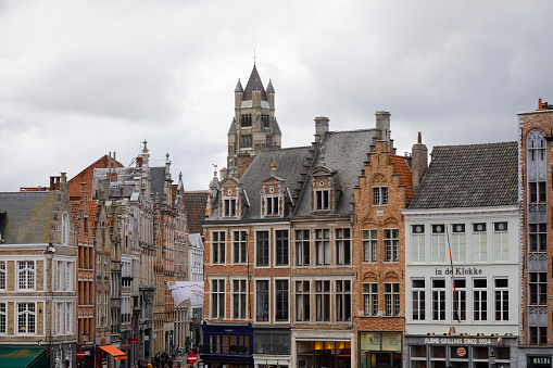 Bruges, Belgium - September 15, 2022: The Market Square, Markt is surrounded by magnificent houses with mainly brick facades.