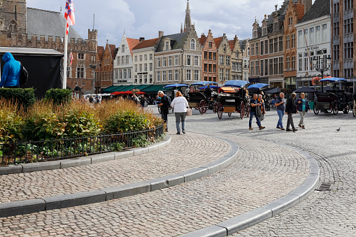 burges/Belgium- Oct 28 2019:crowd tourists walking in Grote Markt square and Belfort tower in Bruges, Belgium.