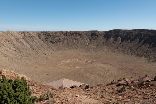 An aerial view of Meteor Crater deserted land on a sunny day