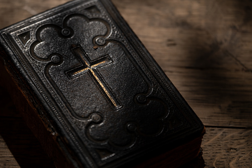 Ancient Holy Bible on wooden background