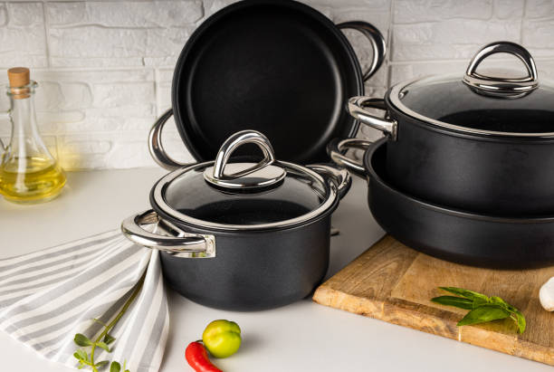 istock Closeup shot of the different type black pots in the white decorated kitchen 1455559614
