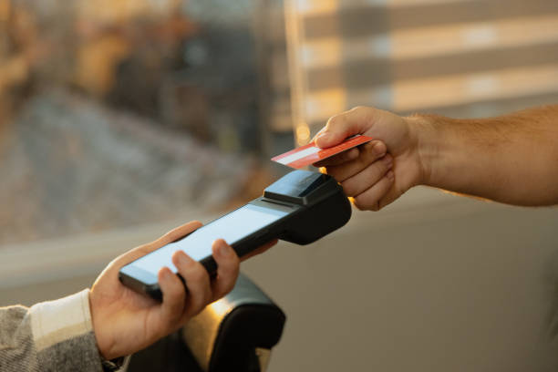 istock Customer paying barber through credit card Contacless payment - Close up shot 1455561438