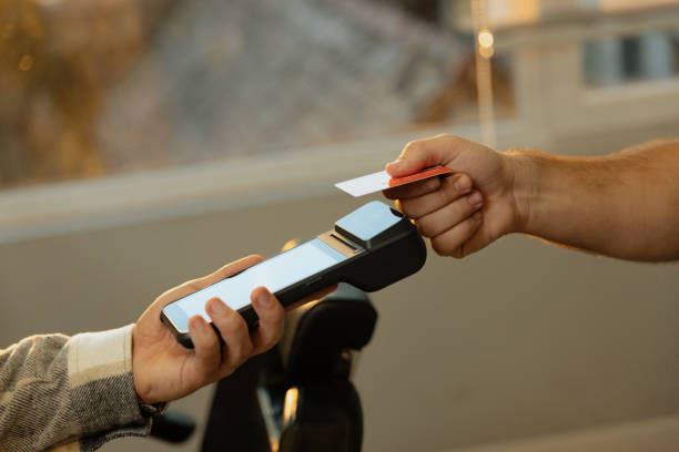 Customer paying barber through credit card Contacless payment - Close up shot