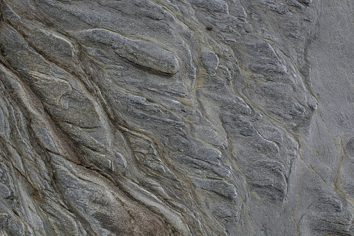 Stone abstract natural background of  rock with strange texture on the beach