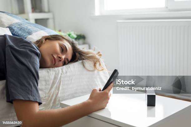 Young Woman Is Waking Up Stock Photo - Download Image Now - Laziness, Women, Alarm Clock