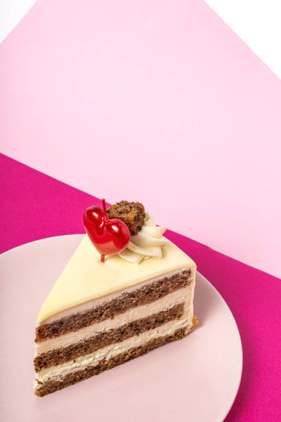 Background of carrot cake with heart candle for Valentine's Day Background of carrot cake with heart candle for Valentine's Day on magenta and pink background carrot cake day stock pictures, royalty-free photos & images