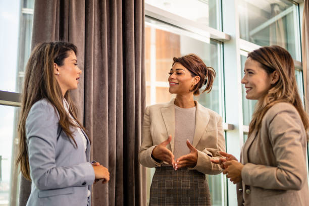 istock Three young female office assistants talking together 1455563843
