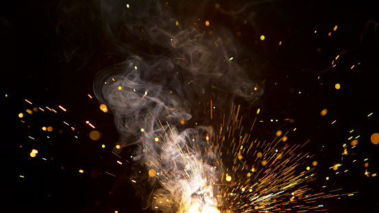 Super Slow Motion of Flying Fire Sparkles. Detail shot, Low Depth of Focus.