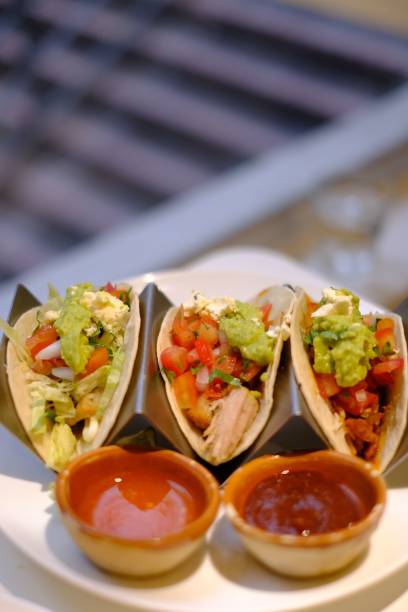 istock Mexican tacos on a plate with sauce 1455564387