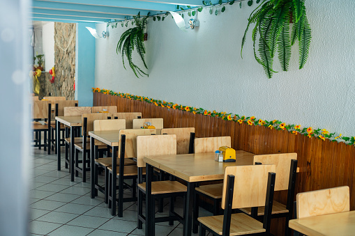 photo of empty restaurant with tables and chairs organized open waiting for its customers