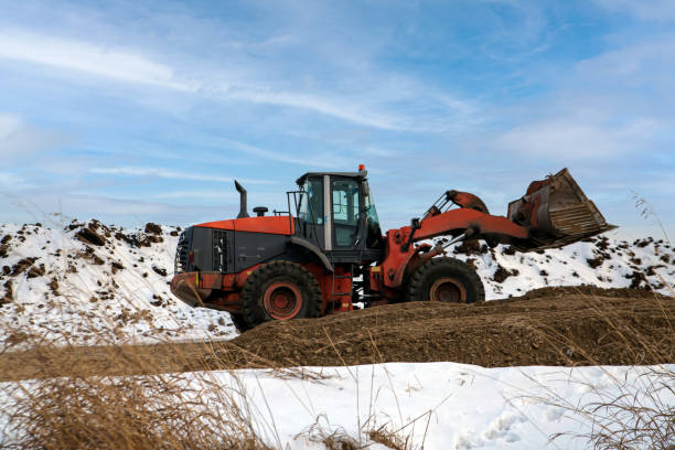 istock Wheel loader digs soil in winter 1455567138