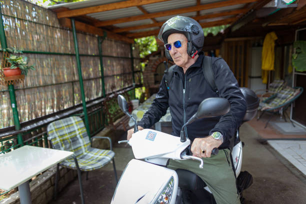 istock Senior man sitting on a motorcycle 1455569022