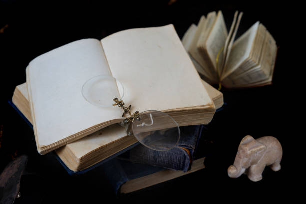 istock Retro still life, old book with blank pages at top of books stack, wisdom concept 1455569877