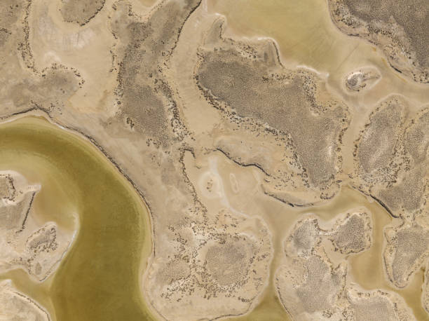 Aerial view of natural shapes and textures Aerial view of beautiful natural shapes and textures on a dried lake. Salt Lake (Tuz Gölü) located at the intersection of Ankara, Konya and Aksaray provinces in the Central Anatolian Region of Türkiye. Taken via drone. lake bed stock pictures, royalty-free photos & images