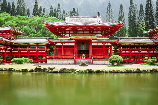 Oahu Hawaii -- 4/28/2013: Buddhist Byodo-in Temple sits at the foot of the Koolau Mountains in the Valley of the Temples on the island of Oahu in Kaneohe, Hawaii, which is a replica of the temple in Kyoto Japan