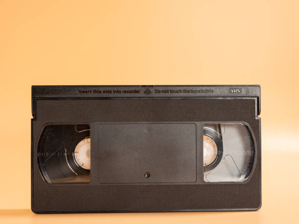 istock Old VHS cassettes on an orange background. Retro video cassettes. 1455579017
