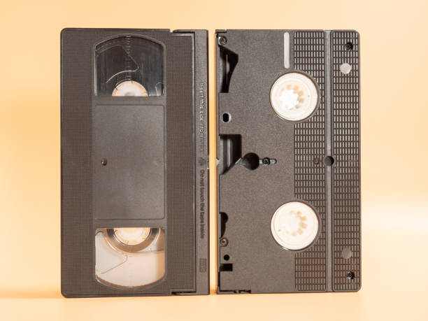 istock Old VHS cassettes on an orange background. Retro video cassettes. 1455579076