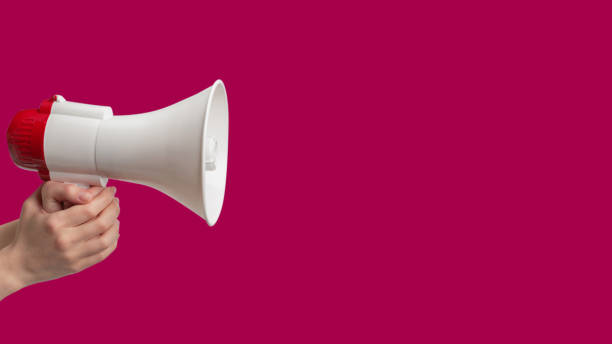 istock Megaphone in woman hands on a purple 1455579750