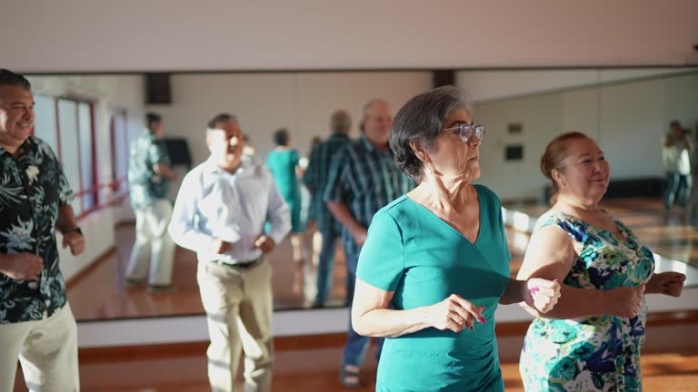 Senior women and her husbands learning dance steps at a dance studio