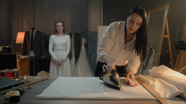 istock Tailor ironing fabric in wedding atelier 1455584436
