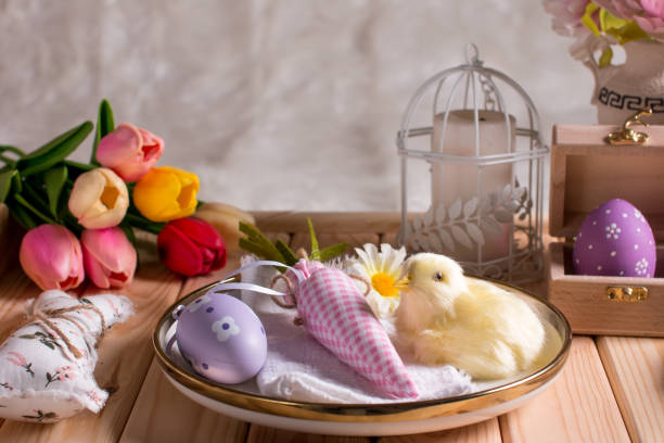 istock Easter decorations on the table, a white knitted napkin. Table decoration rabbit, carrot and painted eggs 1455584686