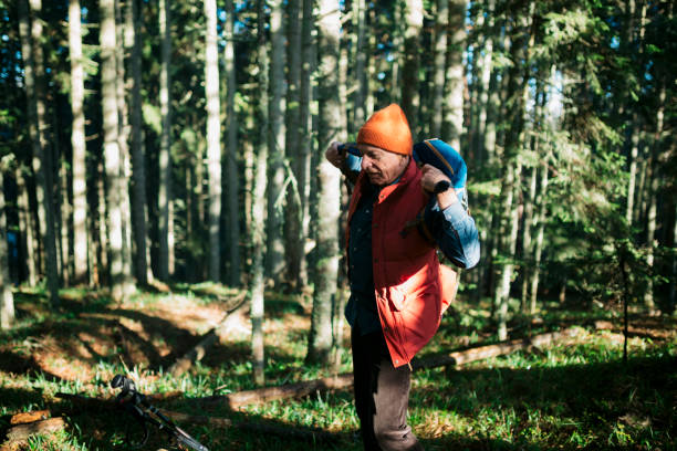 istock Active senior male hiker restarting his forest hike after break 1455585373