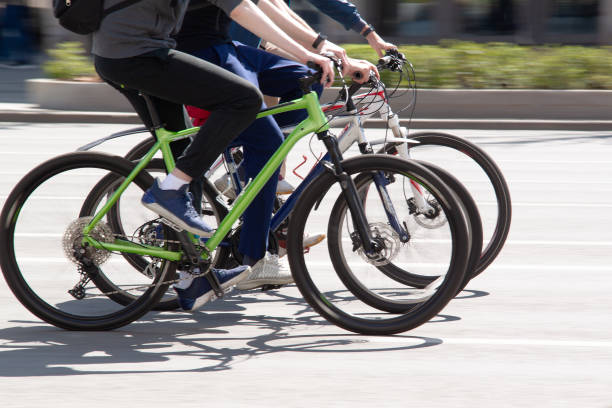 istock three cyclists friends ride bicycles in a sunny summer city 1455585955