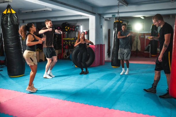 istock Attractive Multiracial People Training With A Boxing Coach 1455586047
