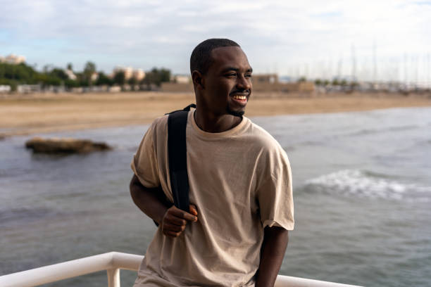 istock Positive black man standing near sea 1455586179