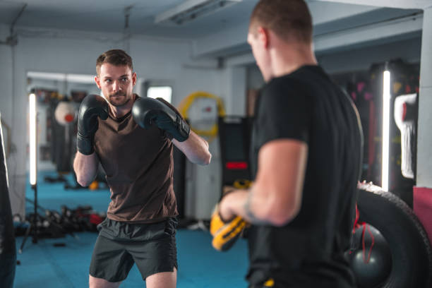 istock Caucasian Male Boxer With Gloves On Practicing 1455587165
