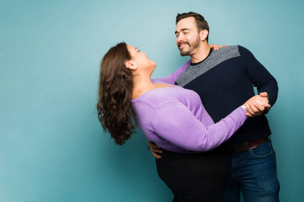istock Happy man dancing with his girlfriend on a romantic date 1455587559