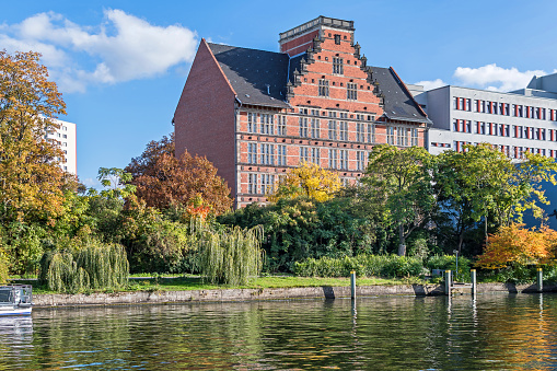 Berlin, Germany - October 9, 2022: Spree river embankment Holsteiner Ufer in a city district Hansaviertel with buildings of a  Gymnasium school