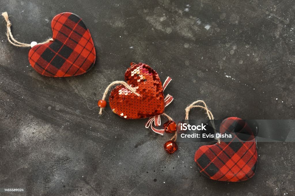 Top view of little red hearts on a black background .Background for Valentine's Day, birthday, holiday, party. Copy space. Abstract Stock Photo