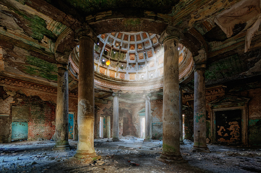 Interior of old ruined palace with columns and dome